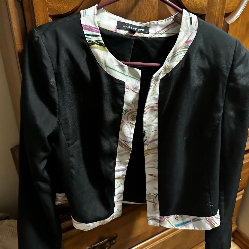Very cute blacks and white blazer with some flower lining on the top